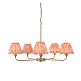 Endon Caldmere 5 light pendant with antique brass arms and tapered pleated coral ikat fabric shades, suspended from a chain on a plain background.