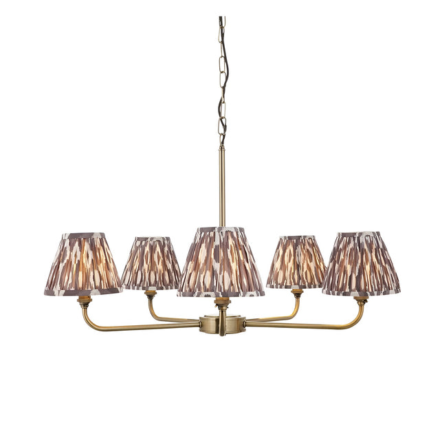 Caldmere 5 Light Ikat Pendant in Grey, five tapered pleated fabric shades on antique brass arms with chain suspension, shown on a plain white background.