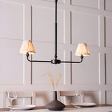 Endon Caldmere 2 Light Ikat Pendant in matt black with two tapered natural pleated shades on a linear frame, shown above a dining table.