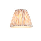 Endon Caldmere tapered pendant shade in pleated natural ikat-print fabric with taped edging, shown illuminated on a plain white background.