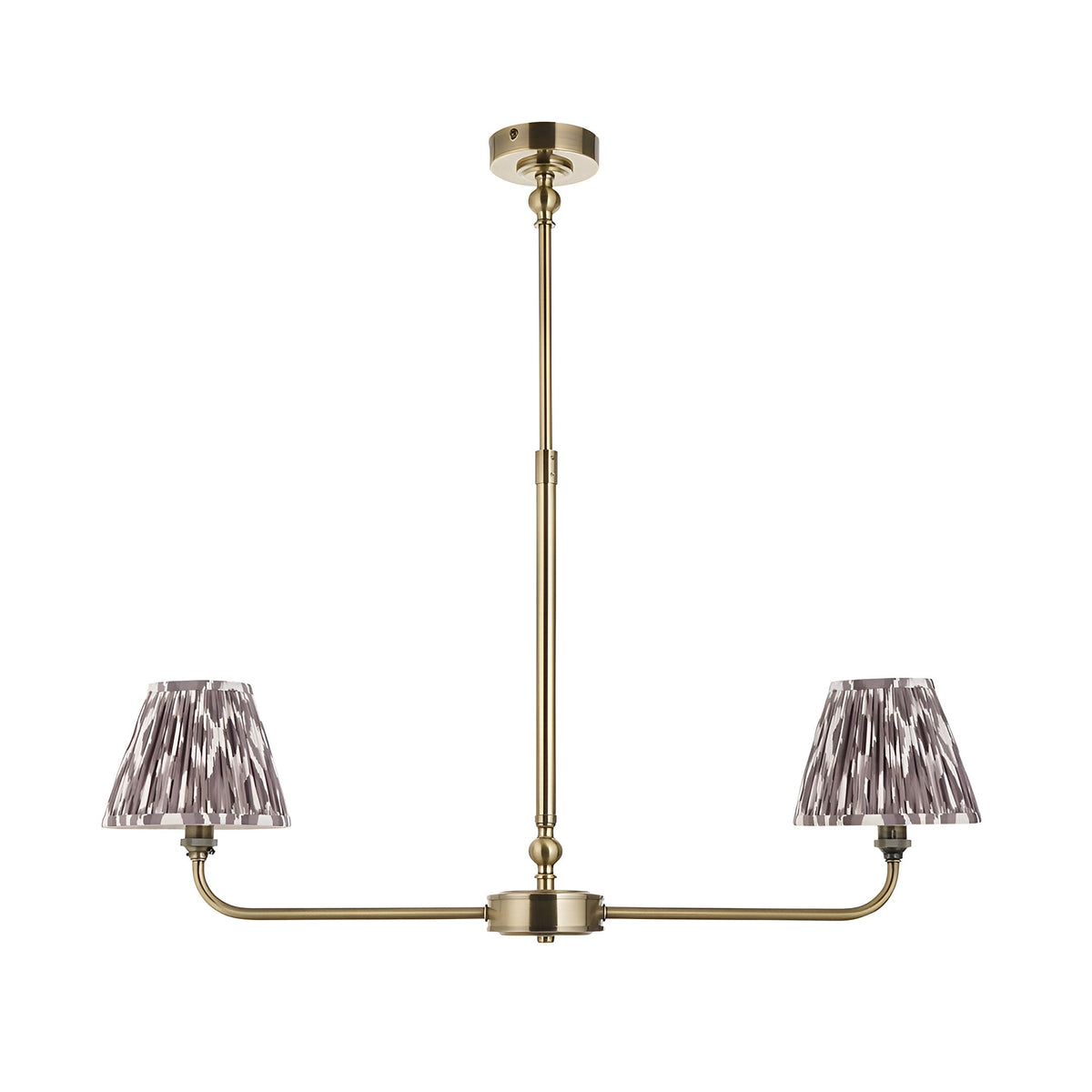 Caldmere 2 Light Ikat Pendant in Grey, a linear antique brass frame with two tapered pleated shades in pearl grey fabric, shown on a plain white background.