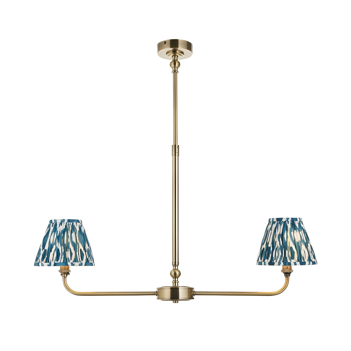 Endon Caldmere 2 light pendant with tapered pleated blue ikat fabric shades on a linear antique brass telescopic stem, on a white background.