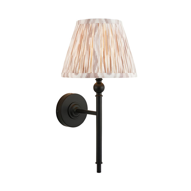 Endon Caldmere wall light with a tapered pleated beige Ikat fabric shade on slim matt black metalwork, shown against a plain white background.