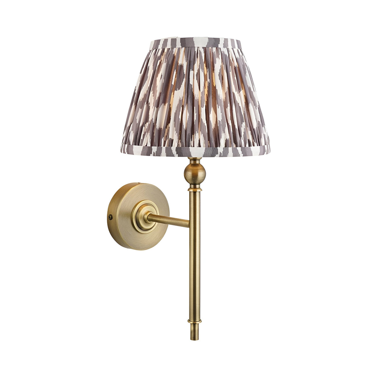 Endon Caldmere wall light with tapered pleated grey Ikat fabric shade and antique brass arm, ball detail, and round backplate on a white background.