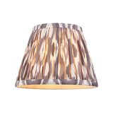 Endon Caldmere tapered Ikat lamp shade in pearl grey with hand-pleated fabric and taped edge detailing, shown illuminated on a plain white background.