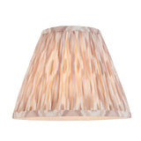 Caldmere Ikat Table Lamp shade in cream with soft brown patterned pleats, empire shape, shown lit against a plain white background.