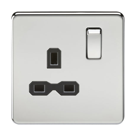 The 13A 1 Gang DP Switched Socket in polished chrome with a black insert showcases a screwless flat plate design. Crafted from premium grade steel, it features a single switch on the top right and three rectangular holes in a triangular pattern for a modern, sleek appearance.