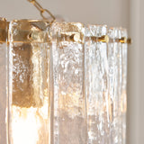 Close-up of the Brockhurst 3 Light Pendant, showing clear handmade textured glass panels ringed by a brass band with visible fixing screws.