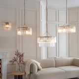 Endon Brockhurst pendant lights with textured glass panels and brass frames hang above a cream sofa in a panelled living room with matching wall light.