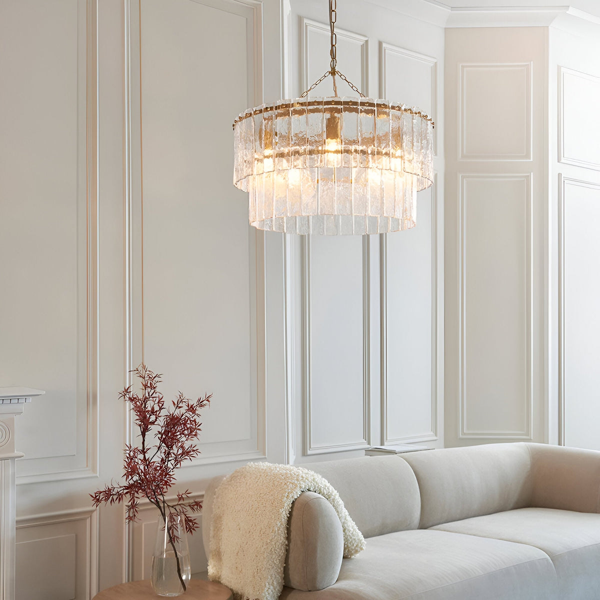 Endon Brockhurst 5 light chandelier with two tiers of textured glass panels and brushed aged brass frame, hanging in a panelled living room.