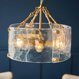 Brockmont 4-Light Pendant in brass with a cylindrical rippled glass shade, visible bulbs, brass fixings, and chain suspension.