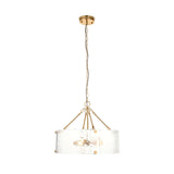 Endon Brockmont 6 light pendant with a rippled handmade glass cylindrical shade, brushed aged brass frame and chain suspension on a white background.