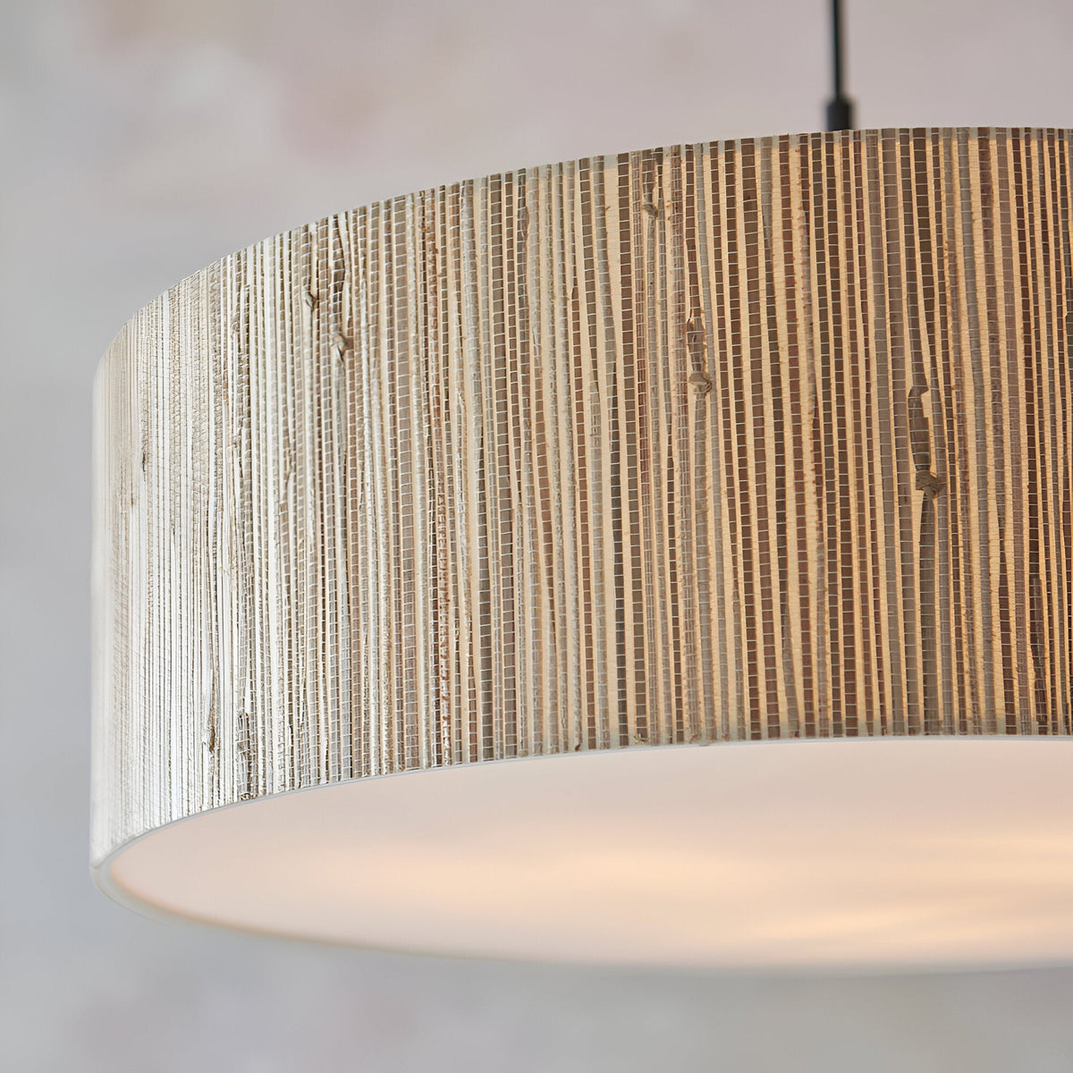 Endon Salcombe 3 Light Pendant close-up showing the cylindrical woven natural seagrass shade, white fabric diffuser below, and matt black cable.