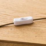 Endon Brockbourne inline on/off switch in white plastic on a taupe fabric flex, resting on a light oak wood surface.