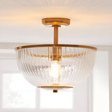 Endon Langton flush uplighter with brass fitting and ribbed clear glass bowl diffuser, mounted to a white ceiling near a bright window.