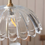 Close-up of Endon Bevcombe clear glass pendant shade showing scalloped domed form with ribbed detail and brass lamp holder fitting.