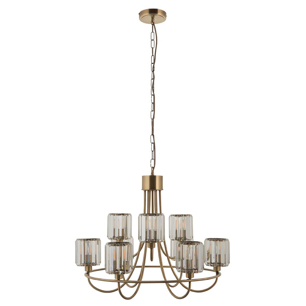 Clementine 9 Light Tiered Chandelier in antique brass with faceted glass shades on two tiers, hung from a chain, plain white background.