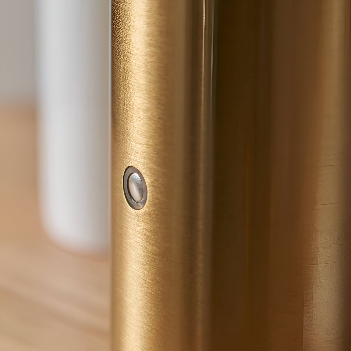 Close-up of the Cranbourne LED Table Lamp in brushed brass, showing the metal column texture and touch dimmer button.