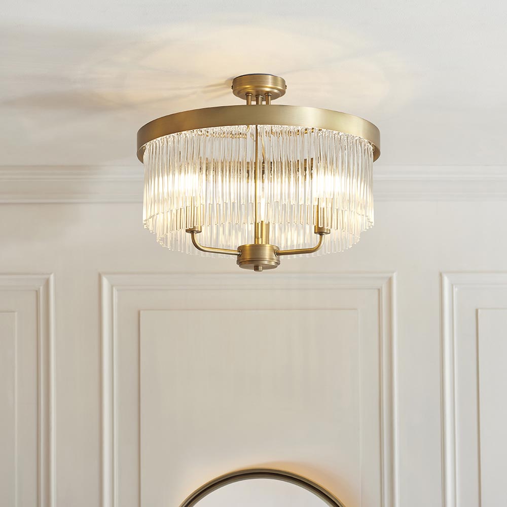 Endon Chatsworth 3 light semi-flush ceiling light in antique brass with tiered glass rod shades, mounted on a panelled hallway ceiling.