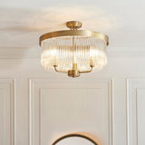Endon Chatsworth 3 light semi-flush ceiling light in antique brass with tiered glass rod shades, mounted on a panelled hallway ceiling.