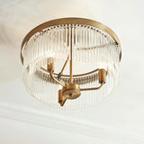 Endon Chatsworth 3 Light semi-flush ceiling light in antique brass with tiered glass rod shades, viewed from below against a white ceiling.