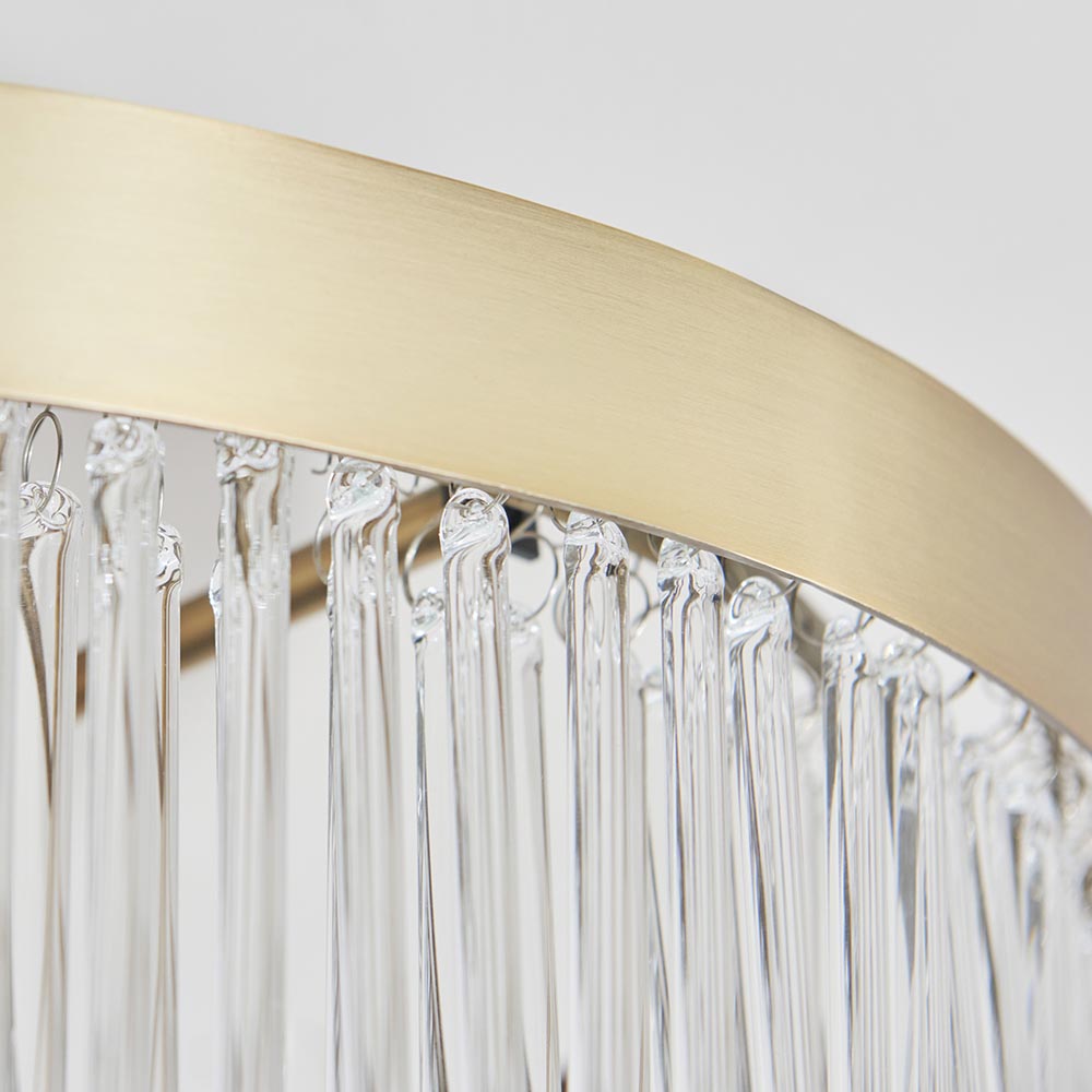 Close-up of the Endon Chatsworth semi-flush ceiling light showing its antique brass circular band above a fringe of clear glass rod shades.