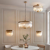 Endon Chatsworth 5 Light Pendant in antique brass with tiered clear glass rods, shown with matching wall lights and semi-flush ceiling light in a dining room.