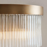 Close-up of the Chatsworth 2 Light Wall Light in antique brass, showing the brushed metal frame with cascading clear glass rods and warm glow.