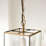 Endon Haddon Grand Pendant close-up in brushed aged brass, showing chain suspension, black fabric flex, square glass lantern top and E27 bulb holder.