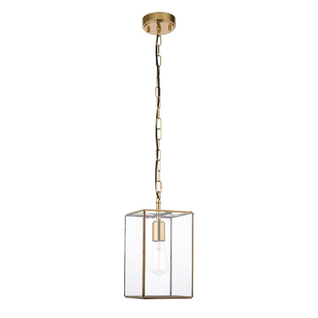 Haddon Pendant in brushed brass, single-light lantern-shaped fixture with clear glass panels and exposed E27 bulb, hung from a brass chain.
