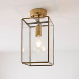 Endon Haddon flush ceiling light in aged brass with a rectangular clear glass shade and single E27 bulb, shown against a plain white ceiling.