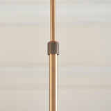 Close-up of the Endon Bramwick pendant's antique brass telescopic stem with a ridged adjustment collar, shown against a soft neutral background.