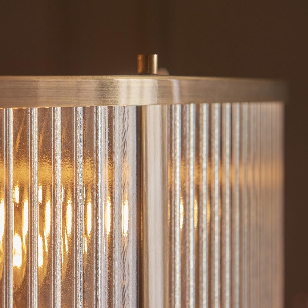 Close-up of Endon Rothbury 8 Light Pendant in antique brass, showing clear ribbed glass panel shades and the brushed brass top frame.