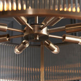 Close-up of the Endon Rothbury 8 Light Pendant in antique brass, showing the central hub, radiating arms, E14 lamp holders and ribbed glass panels.