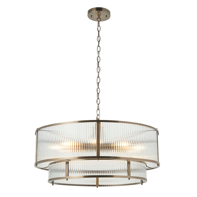 Endon Rothbury 8 light tiered chandelier in antique brass with clear ribbed glass panel shades over two tiers, suspended on a chain against a white background.
