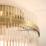 Close-up of the Endon Beaumont flush ceiling light showing its antique brass band and vertical clear glass rod shade.