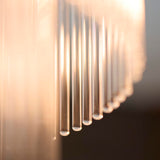 Close-up of the Endon Beaumont flush ceiling light's glass rods, backlit to show warm amber tones along the clear vertical shade elements.