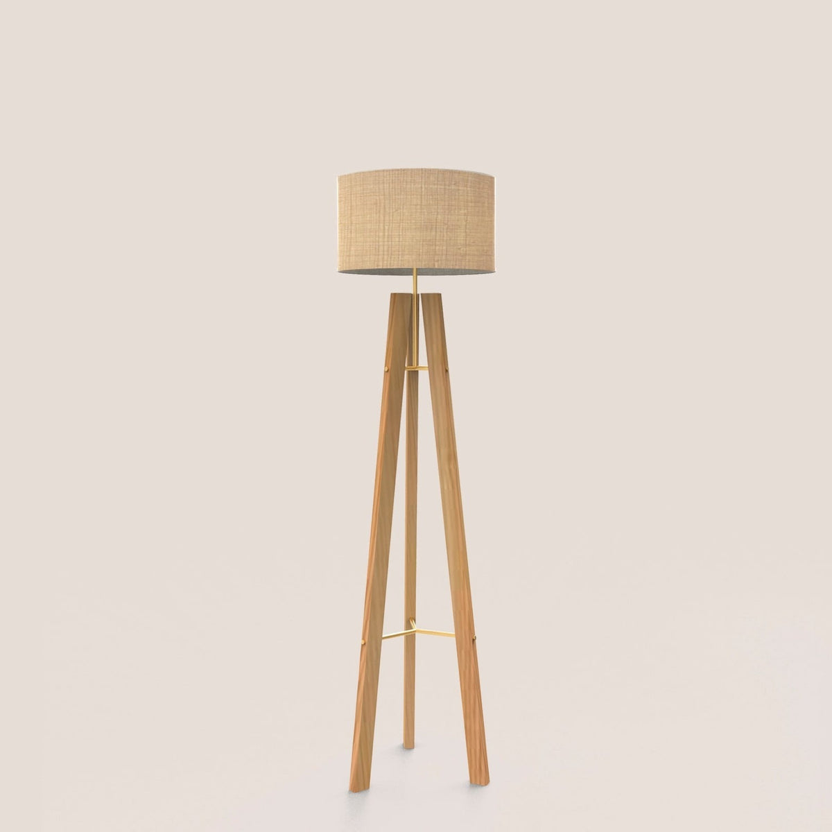 Breeze Fabric Drum Tripod Floor Lamp with a natural fibre drum shade on slim wooden tripod legs braced in gold-finish brass, shown against a plain light background.