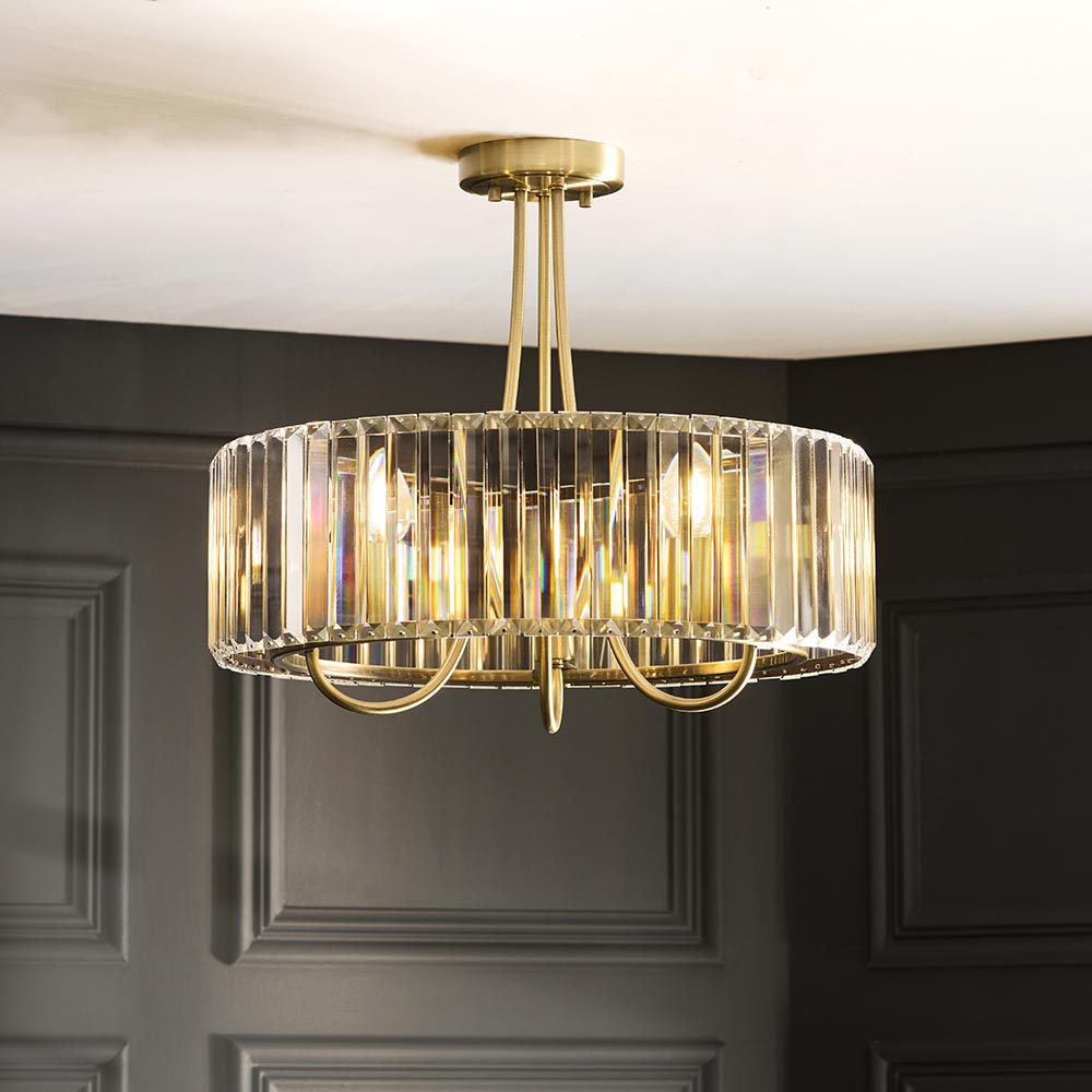 Fairfax 3 Light Semi-Flush Ceiling Light in antique brass with crystal glass panels, shown suspended from a dark panelled ceiling.