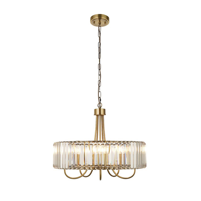 Fairfax 5 Light Pendant in antique brass with a round frame of clear cut glass panels, suspended from a chain on a plain white background.