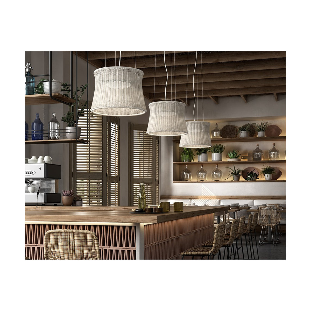Syra 45 Aluminium LED Pendant Lights with woven ivory-white drum shades hanging at varying heights above a wooden bar counter in a rustic café setting.