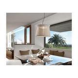 Syra 60 Aluminium LED Outdoor Pendant Light with ivory white woven drum shade, waisted shape, hung above a glass dining table in a sunlit room with garden views.