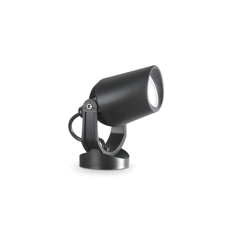 The Otis-2 Outdoor Single Spotlight - Black features a compact design with a cylindrical head and swivel base, perfect for adjustable directional lighting. Built to be durable, it is positioned on a flat white surface, angling slightly upward.