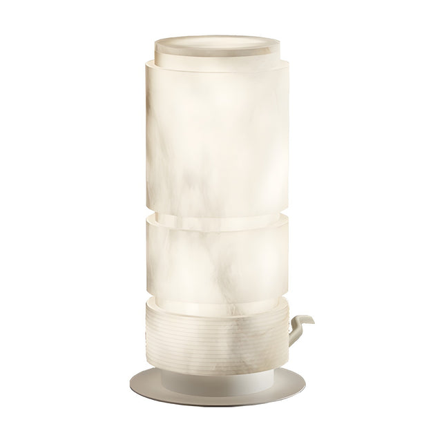 Bowie LED Cylinder Alabaster Table Lamp with stacked tiered column shade, ribbed white cap, iron base and switch, softly glowing to reveal grey veining, on a plain white background.