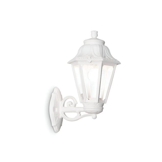 Introducing the Gaze Large Outdoor Wall Light in White, which features a vintage-style design with ornate detailing and a hexagonal glass enclosure. It includes an anti-yellowing diffuser and UV treatment for durability, all mounted on a bracket with decorative scrollwork.