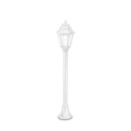 The Gaze 1 Light Lamp Post - White is a tall, slender outdoor lighting solution with a vintage-style lantern-shaped top. Its corrosion-resistant construction and UV-treated finish ensure durability and elegance, making it stand out beautifully against a simple white backdrop.