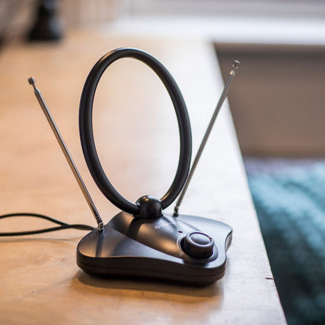 Mercury ST36B Amplified Indoor TV Aerial by AVSL on a wooden surface, with a black loop aerial, two extended telescopic antennas, gain control knob and lead.