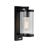 Endon Castbury outdoor wall light in matt black with a cylindrical ribbed glass shade, E27 filament bulb and integrated PIR sensor below.