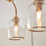Halstead 3 Light Semi-Flush Ceiling Light in aged brass, close-up of clear glass shades with visible E14 filament bulbs on brass arms.