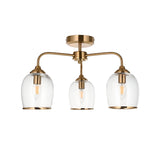 Halstead 3-Light Semi-Flush Ceiling Light in aged brass with three curved arms holding clear glass shades on a slim frame.